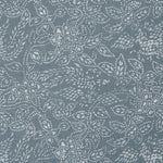 Detail of a linen fabric in a dotted leaf pattern in white on a dusty blue field.