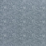printed linen fabric in a dotted leaf pattern in white on a dusty blue field.