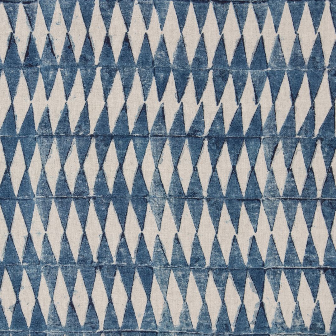Detail of fabric in a diamond stripe print in navy on a cream field.