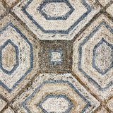 Geometric patterned rug with hexagonal and square shapes in brown and blue tones.