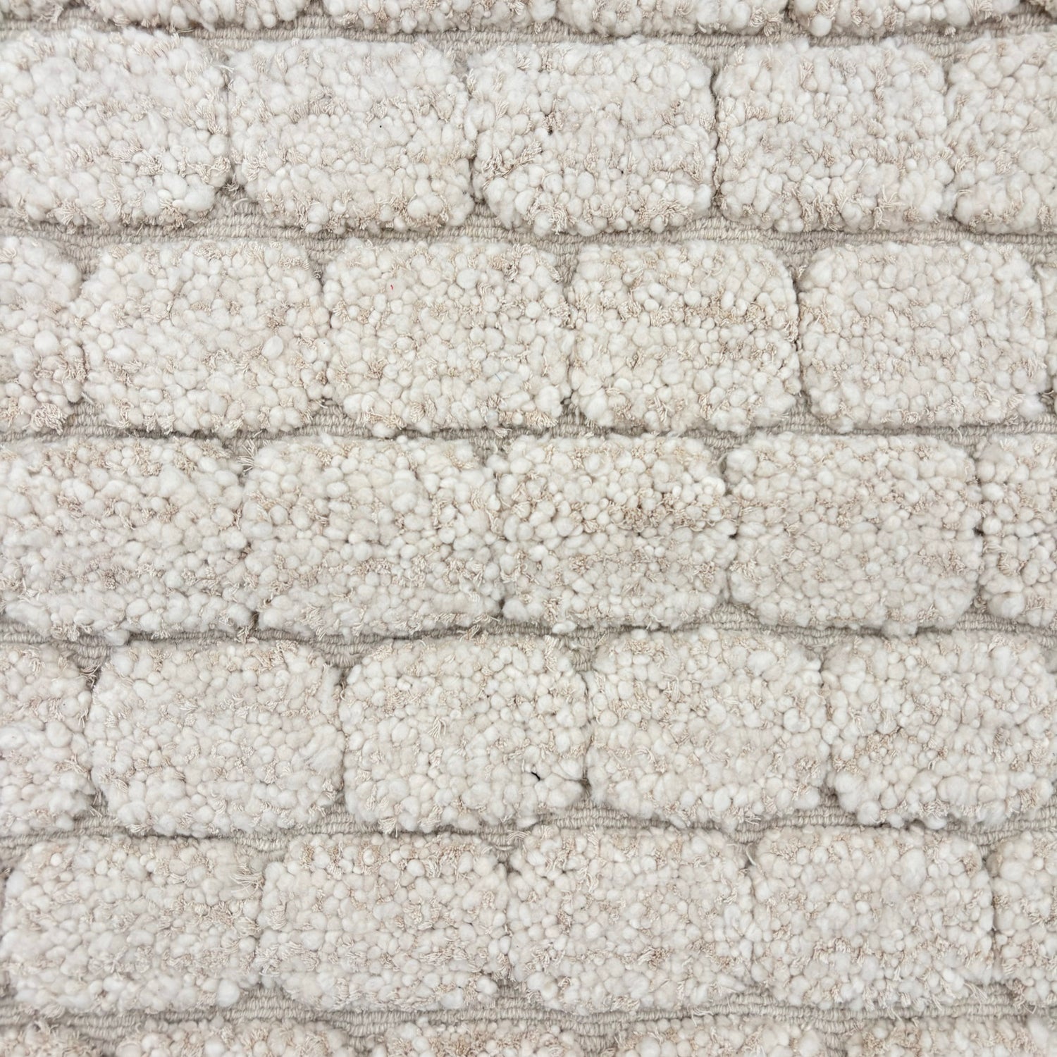 Morrocan handknotted rug sample with a raised brick pattern in ivory.