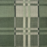 Handwoven rug in a large scale plaid in shades of green and white. 