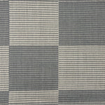 Handwoven rug in a large scale grey and ivory checkerboard pattern. 