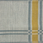 Handwoven rug in a large scale plaid in shades of cream, teal and yellow.