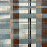 Handwoven rug in a large scale plaid in shades of teal, brown, tan, cream and black. 