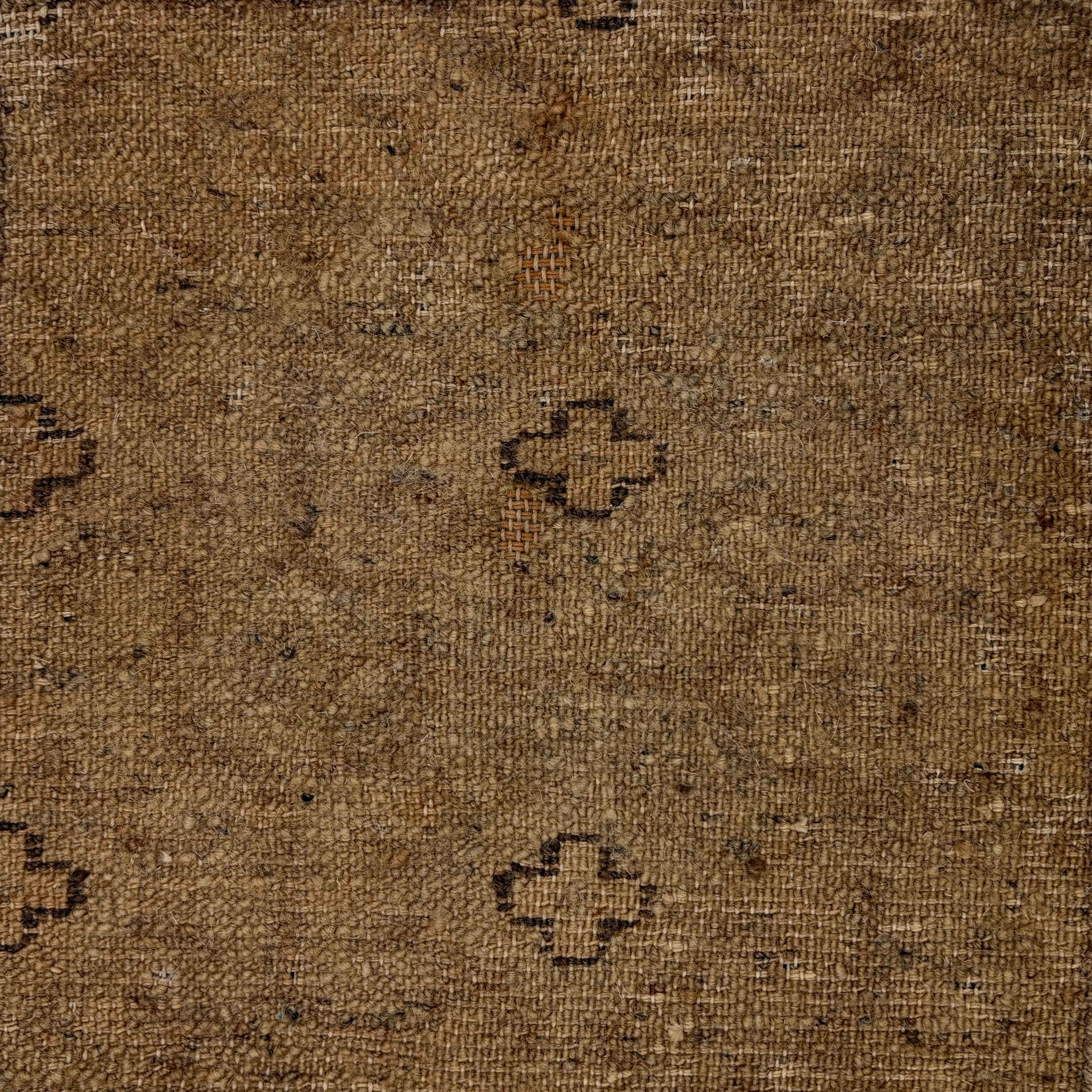 Handwoven rug with small black cross outlines on a brown field. 