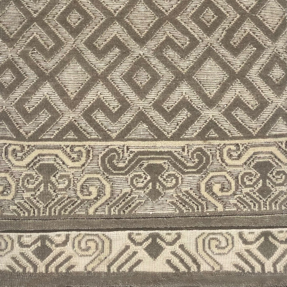 Handknotted rug sample in an old world lattice design with a decorative border in shades of taupe. 