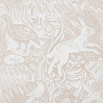 Detail of wallpaper in a playful rabbit and bird print in tan on a white field.
