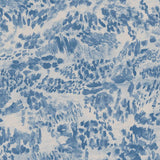 Detail of fabric in a painterly cloud print in shades of blue and navy on a cream field.