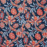 A close-up of a fabric pattern featuring stylized botanical motifs with coral-red and light blue flowers and leaves on a dark navy blue background.