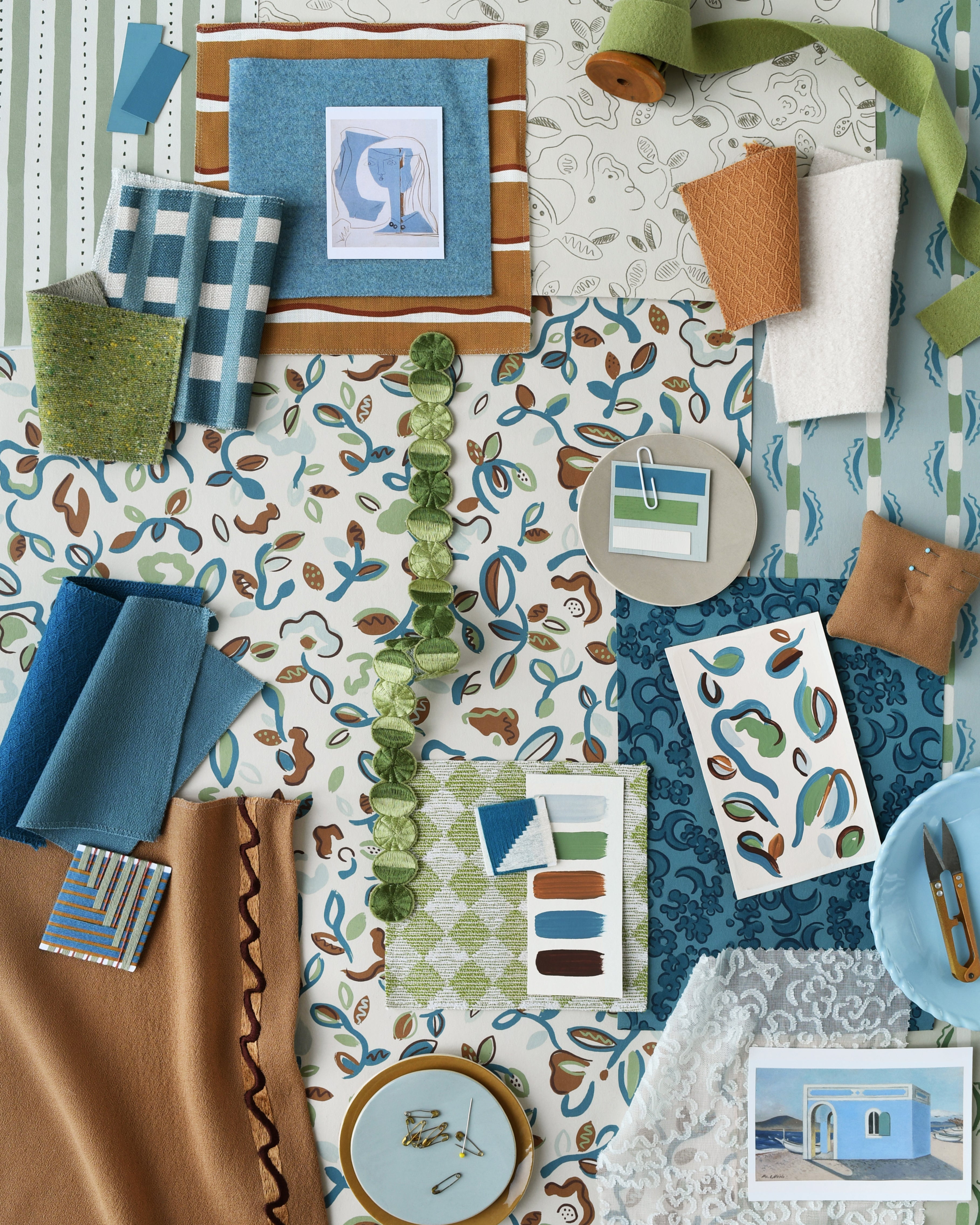 Collection of fabric swatches and design elements in blue, green, and brown on a patterned background.