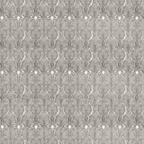 Detail of fabric in an art deco damask print in black on a white field.