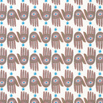 Detail of wallpaper in a playful hamsa hand print in brown, pink and blue on a white field.