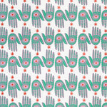 Detail of wallpaper in a playful hamsa hand print in green, pink and red on a white field.