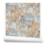 Partially unrolled wallpaper with a pattern of many different types of illustrated watercolor dogs. Background is light blue.