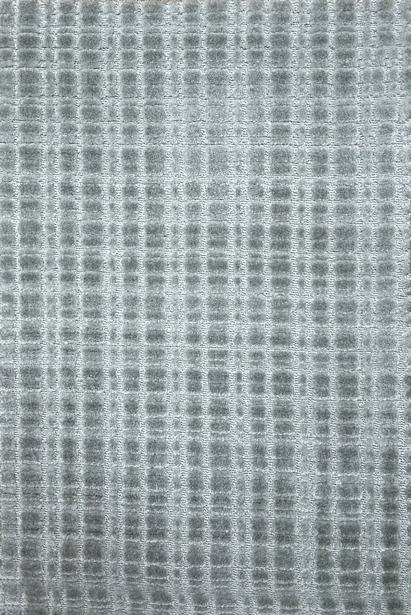Broadloom carpet in a textural grid in cool grey.