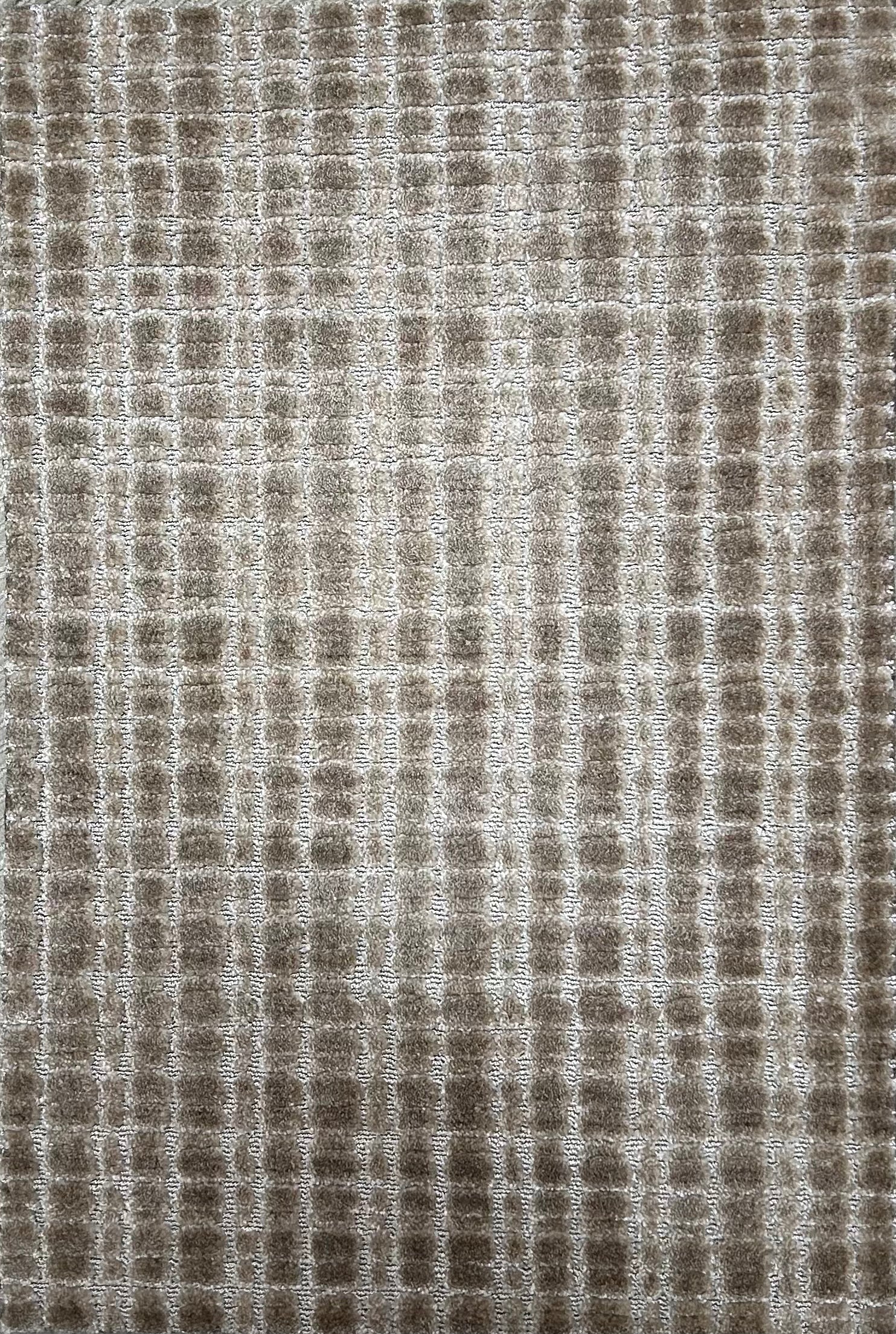 Broadloom carpet in a textural grid in taupe.