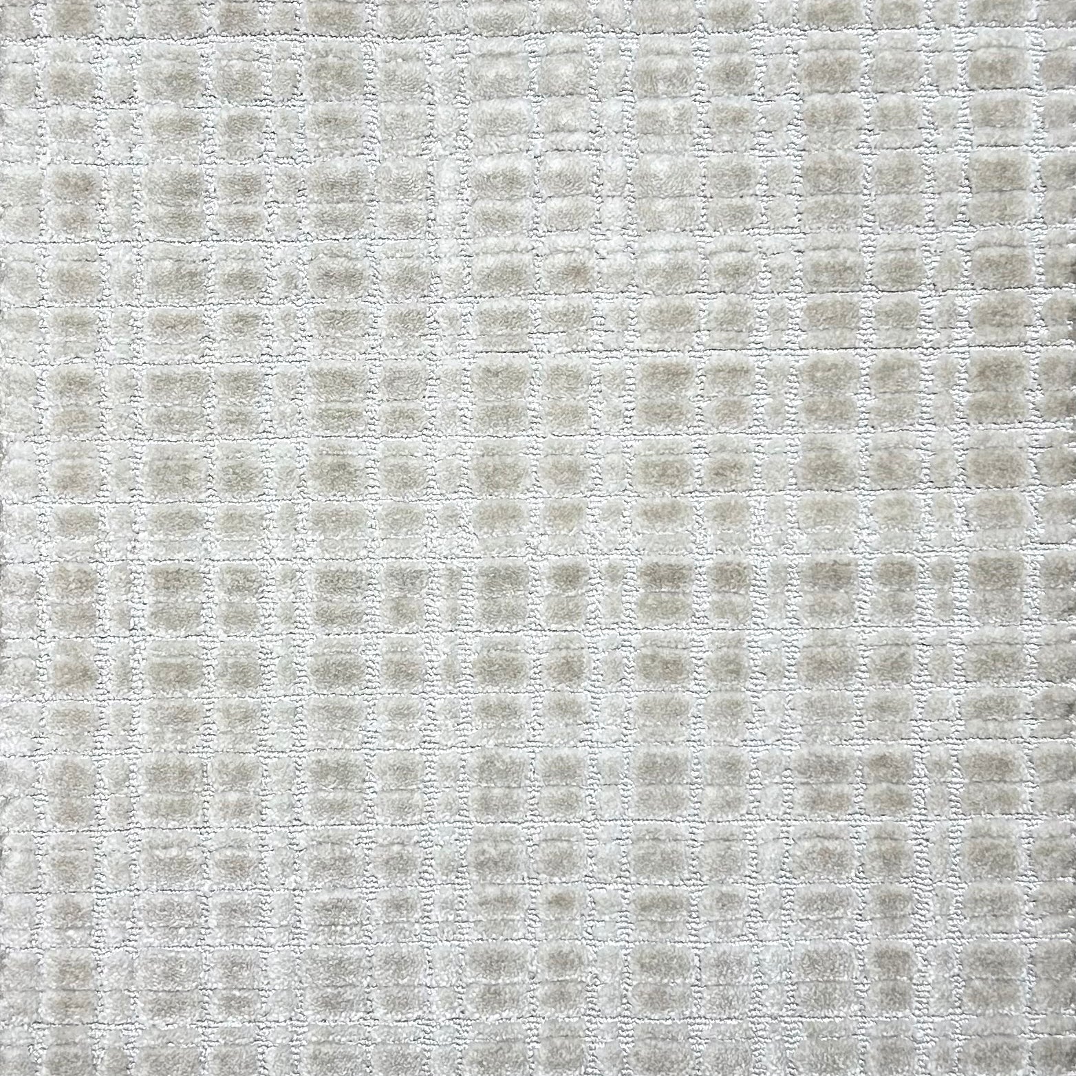 Broadloom carpet in a textural grid in ivory.