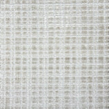 Broadloom carpet in a textural grid in ivory.