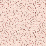 Detail of wallpaper in a painterly floral print in rust and white on a light pink field.