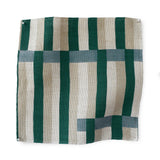 Fabric swatch in a broken stripe design in teal, ocean blue, ecru and cream. 
