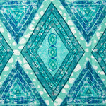 Detail of fabric in an intricate diamond grid pattern in shades of blue and turquoise.