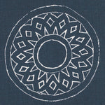 Detail of fabric in a repeating circular geometric print in white on a navy field.