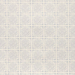 Detail of fabric in a damask lattice print in blue on a cream field.