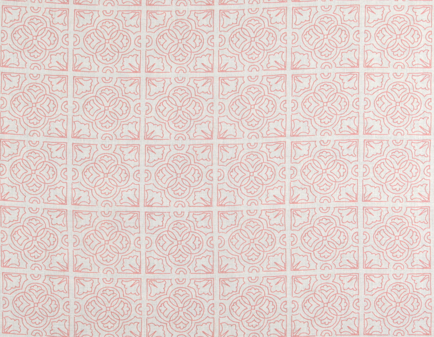 Detail of fabric in a damask lattice print in pink on a white field.
