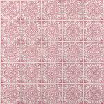 Detail of fabric in a damask lattice print in magenta on a cream field.