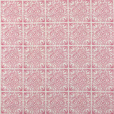 Detail of fabric in a damask lattice print in magenta on a cream field.