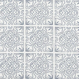 Detail of fabric in a damask lattice print in navy on a white field.