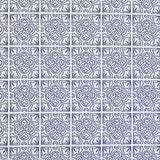 Detail of fabric in a damask lattice print in navy on a white field.