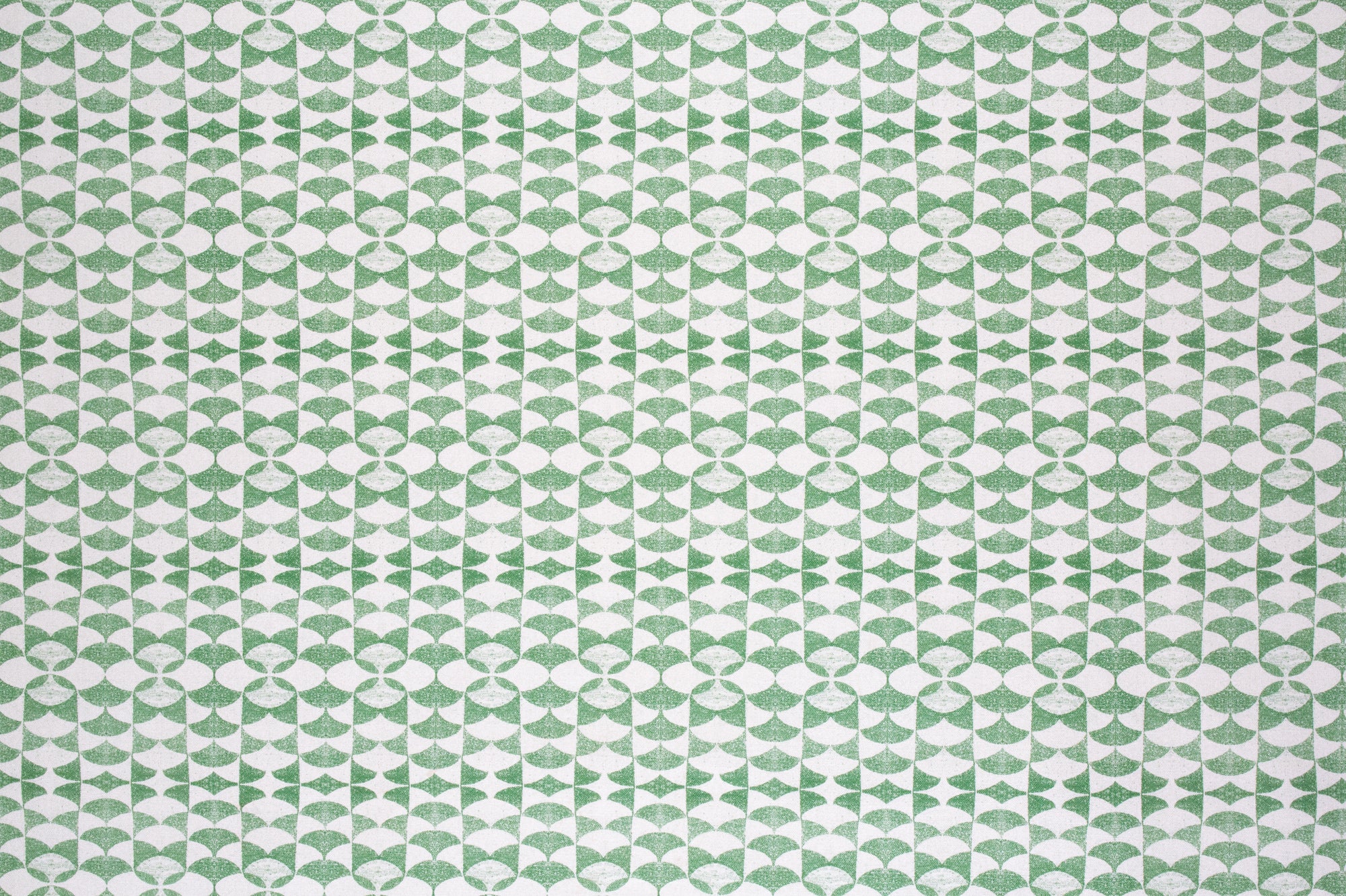 Detail of fabric in a geometric stripe pattern in green on a white field.