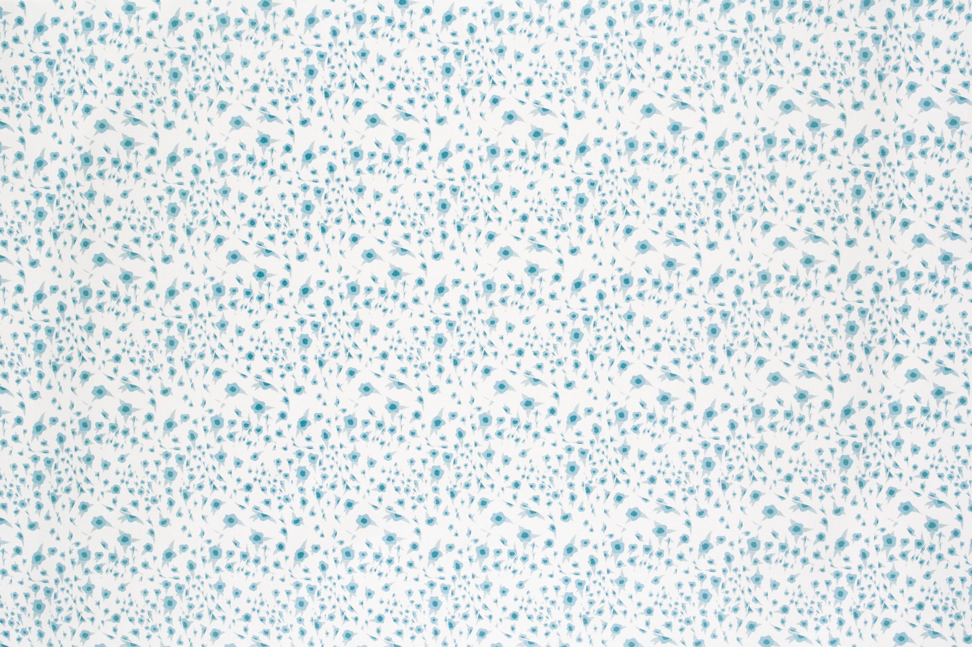 Detail of fabric in a small-scale floral pattern in shades of blue on a cream field.
