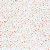 Detail of fabric in a small-scale floral pattern in pink and coral on a cream field.