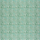 Detail of fabric in a dense triangle grid print in green on a white field.