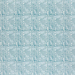 Detail of fabric in a dense triangle grid print in shades of blue on a white field.