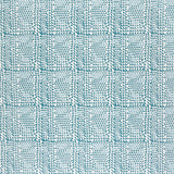 Detail of fabric in a dense triangle grid print in shades of blue on a white field.