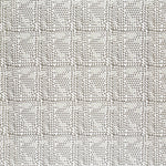 Detail of fabric in a dense triangle grid print in shades of brown on a white field.