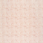 Detail of fabric in a dense triangle grid print in shades of pink and coral on a white field.
