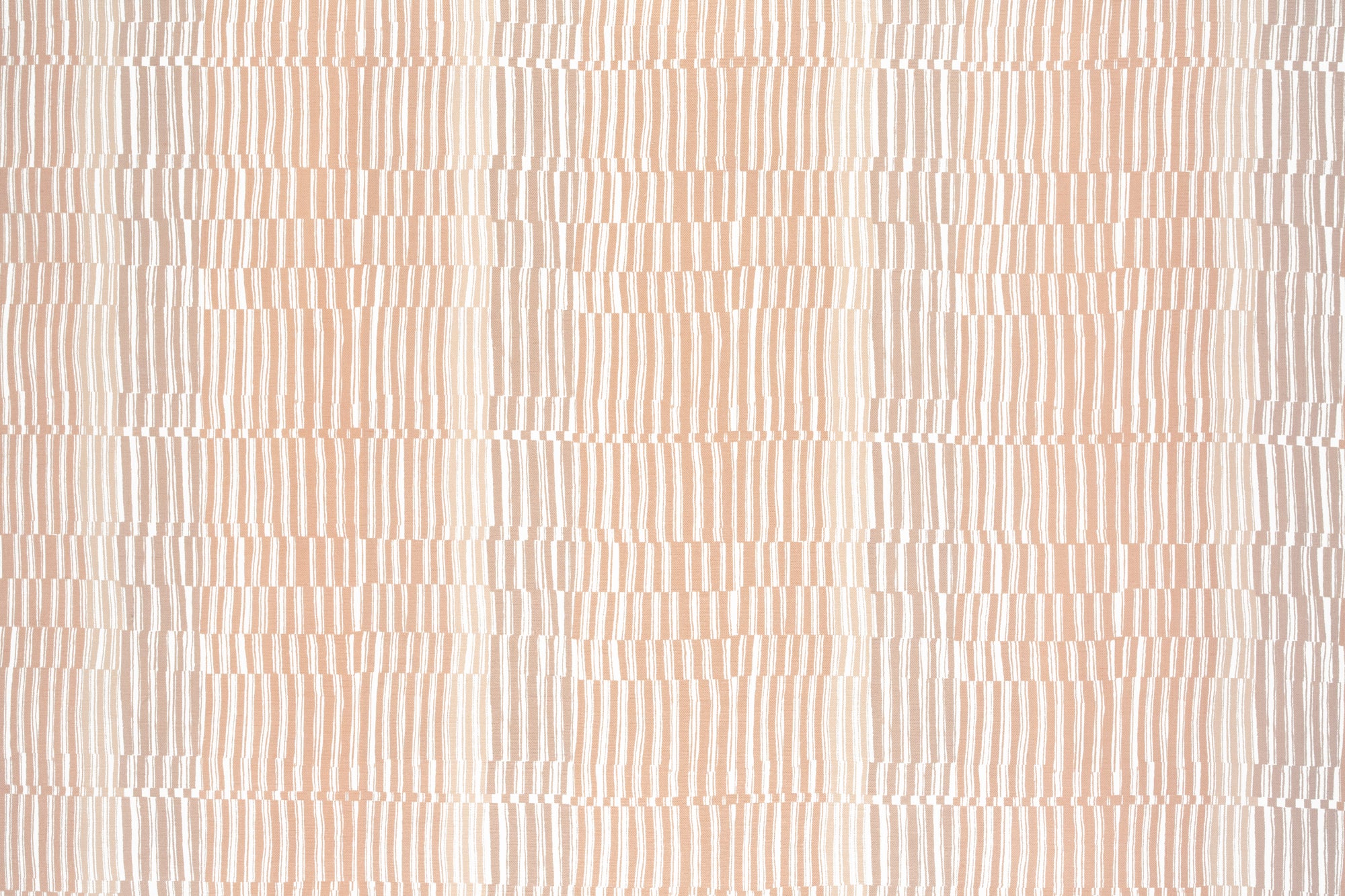Detail of fabric in a dense broken stripe print in shades of peach and white.