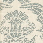 Detail of wallpaper in a mottled damask print in blue-gray on a cream field.