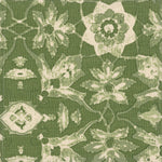 Detail of fabric in a floral damask print in shades of green and cream on a green field.