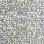 Fabric in a repeating damask print in white and gold on a blue-gray field.