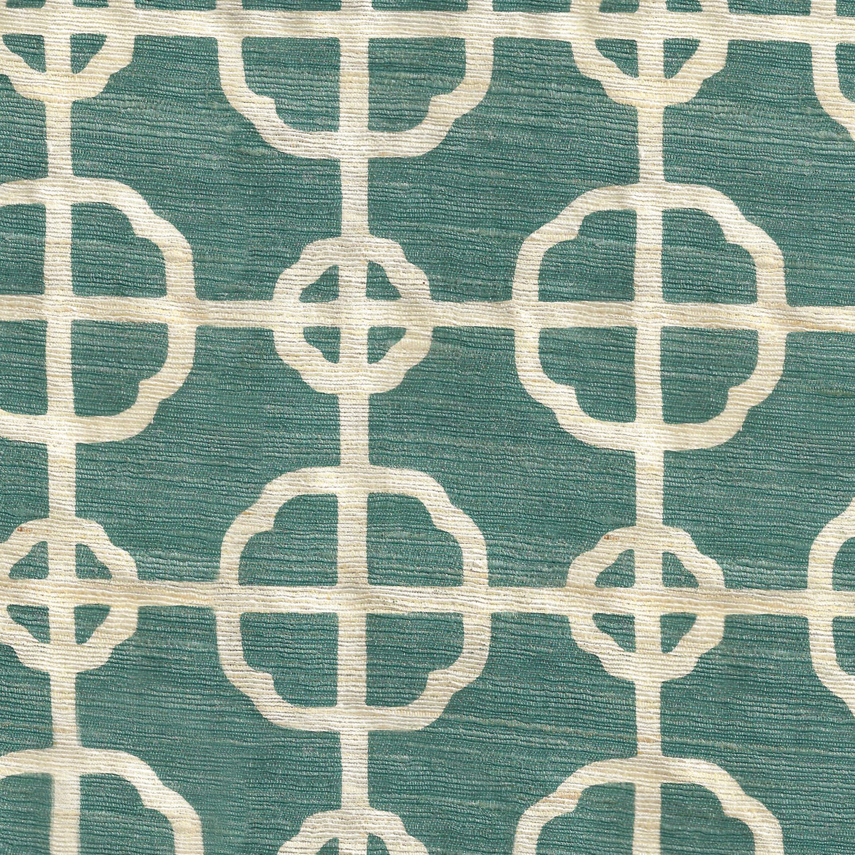 Detail of fabric in a geometric lattice print in white on a turquoise field.