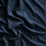Close up of gently draped woven Indoor-Outdoor fabric with dense floral medallion pattern in dark blue on navy blue.