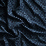 Close up of gently draped woven Indoor-Outdoor fabric with dense floral medallion pattern in dark blue on navy blue.