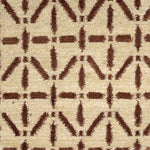 Handknotted rug with brown linear design on a cream field. 