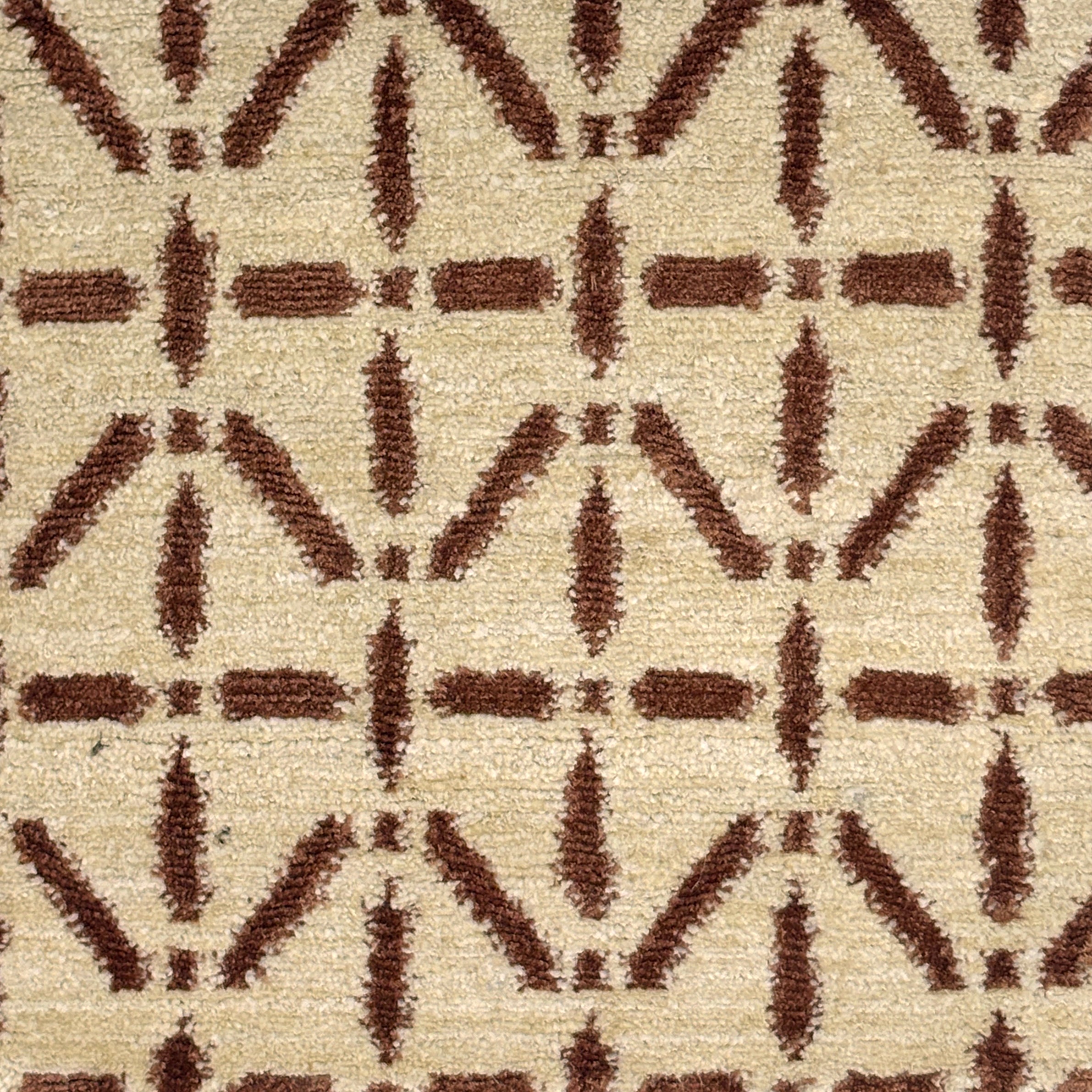 Handknotted rug with brown linear design on a cream field. 